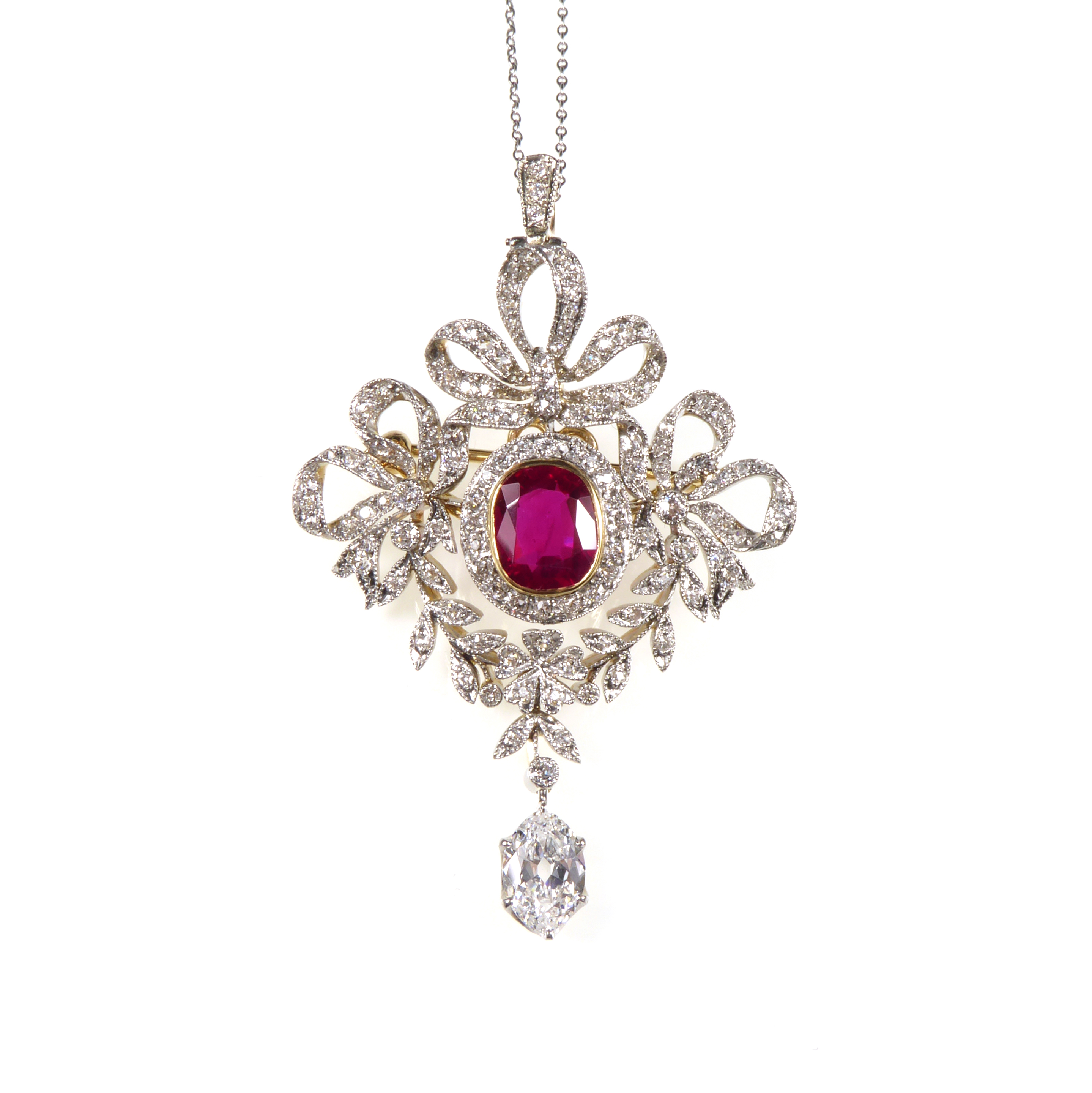 Early 20th century diamond and ruby garland brooch-pendant by Marcus, American c.1905, the central cushion shaped Burma ruby 2.88ct,